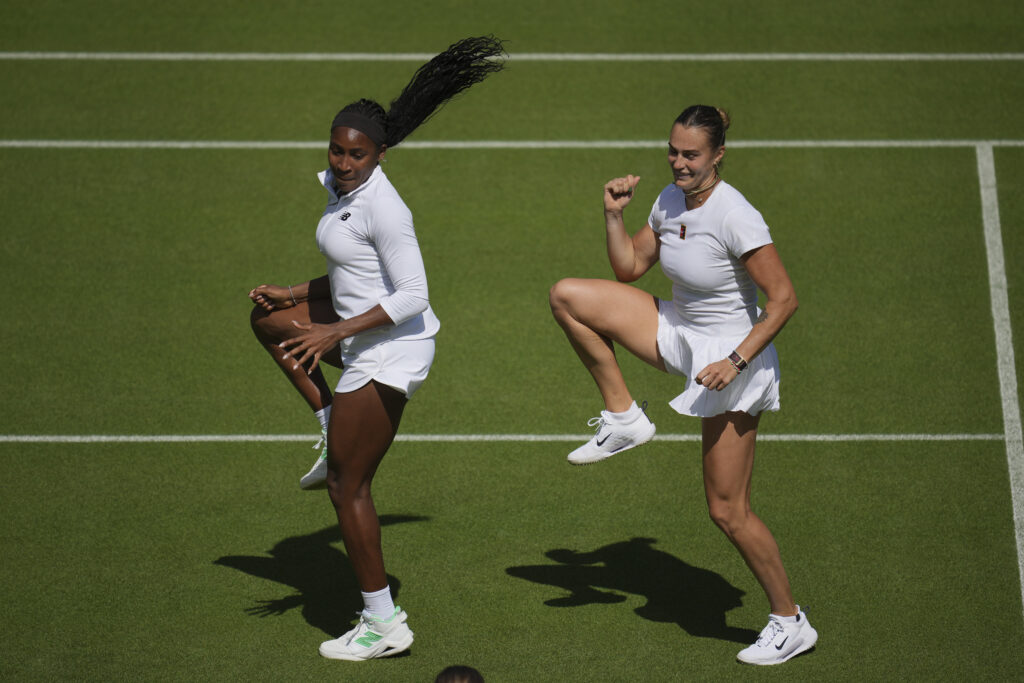 Aryna Sabalenka of Belarus, right, and Coco Gauff of United States dance during a practice session ahead of the Wimbledon Championships in London, Friday, June 27, 2025.