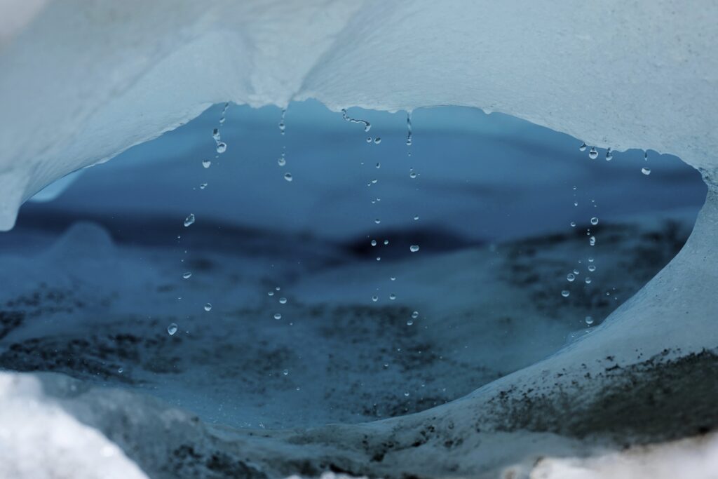 Water drips from a melting chunk of ice that originated from the Rhone Glacier near Goms, Switzerland, June 10, 2025.