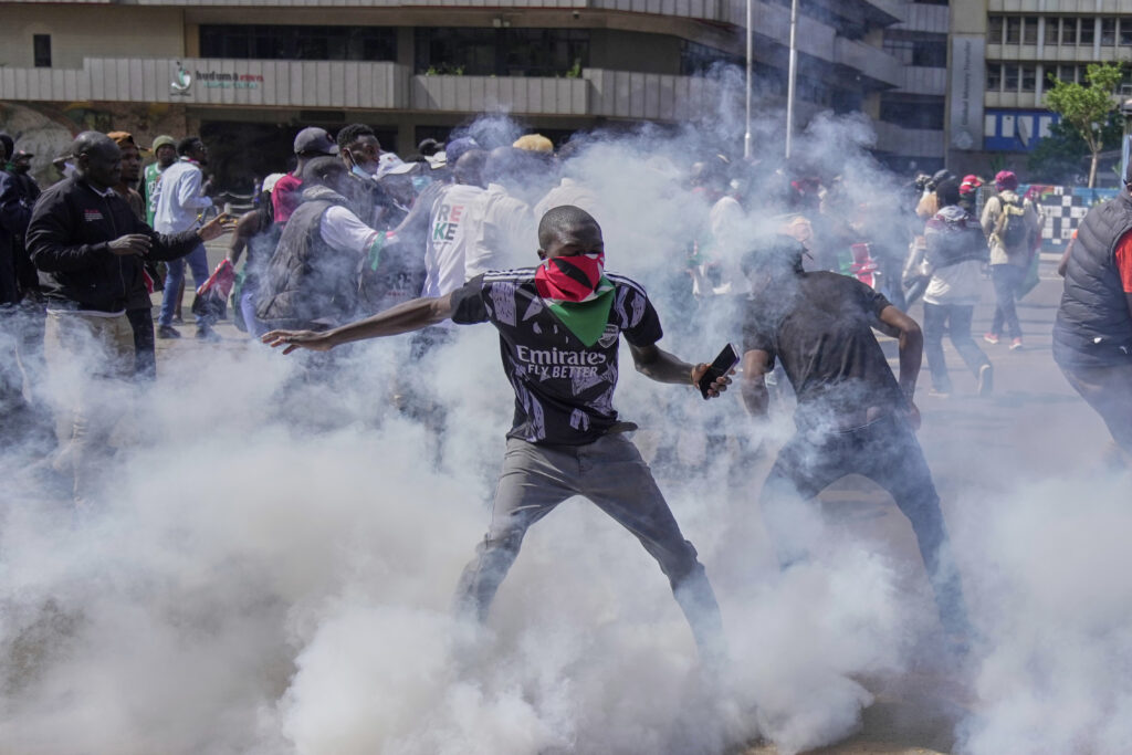 Protesters scatter as police fire teargas at them during a demonstration on the one-year anniversary of deadly anti-tax demonstrations in downtown Nairobi, Kenya, Wednesday, June 25, 2025.