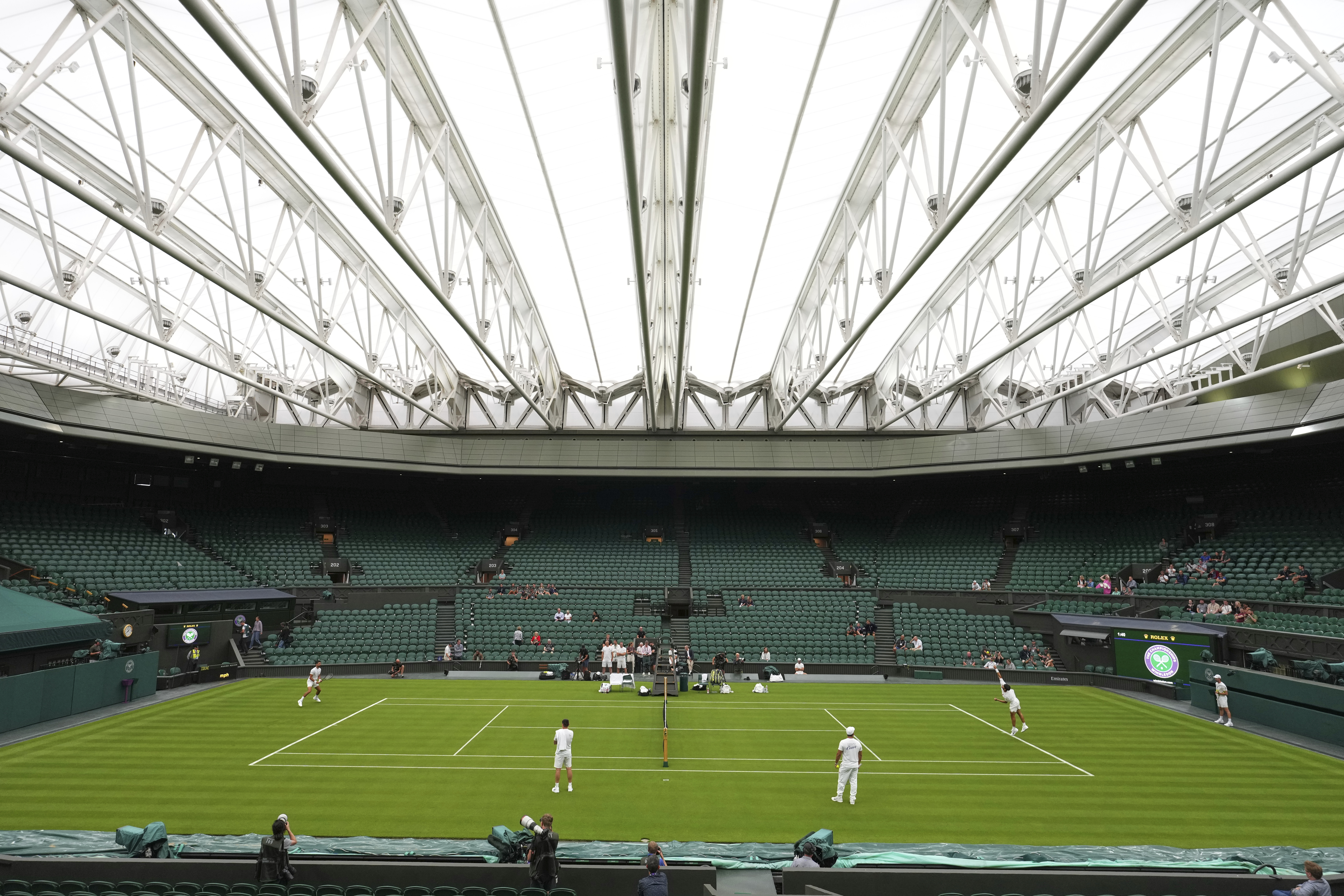 Carlos Alcaraz of Spain, right, and Novak Djokovic of Serbia, left, during a practice session on Centre Court at the All England Lawn Tennis and Croquet Club, ahead of the Wimbledon Championships in London, Thursday, June 26, 2025.