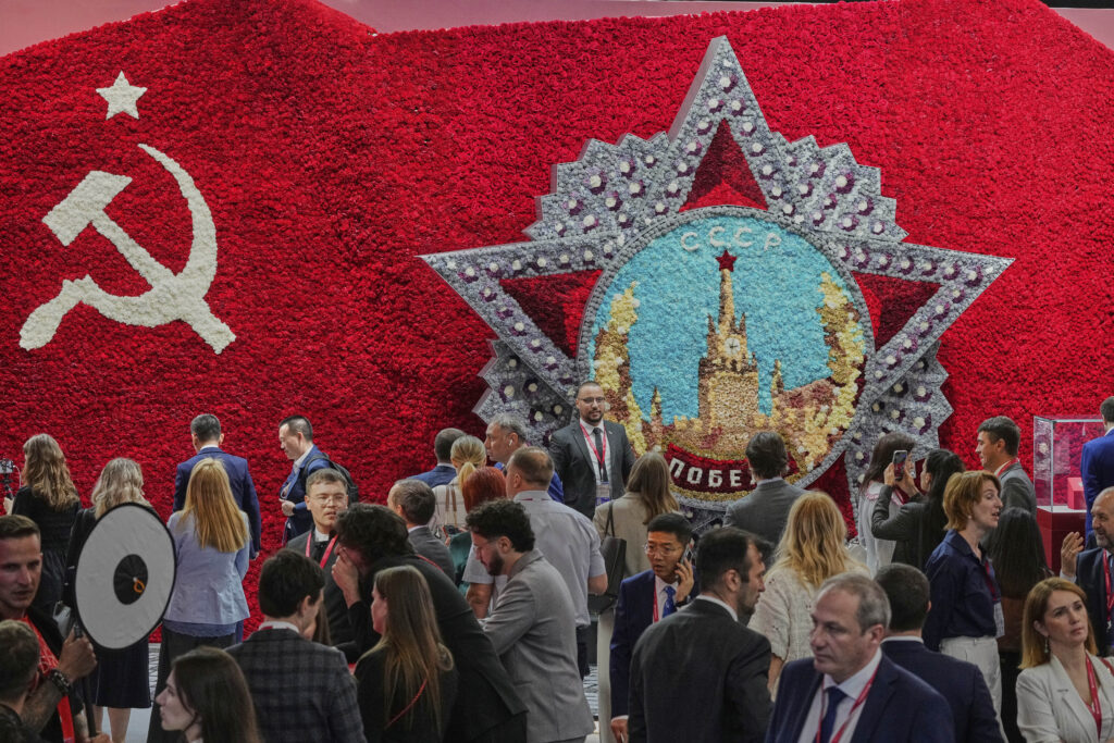 Guests and participants walk in front of a model of the Order of Victory on the sidelines of the St. Petersburg International Economic Forum in St. Petersburg, Russia, Wednesday, June 18, 2025.