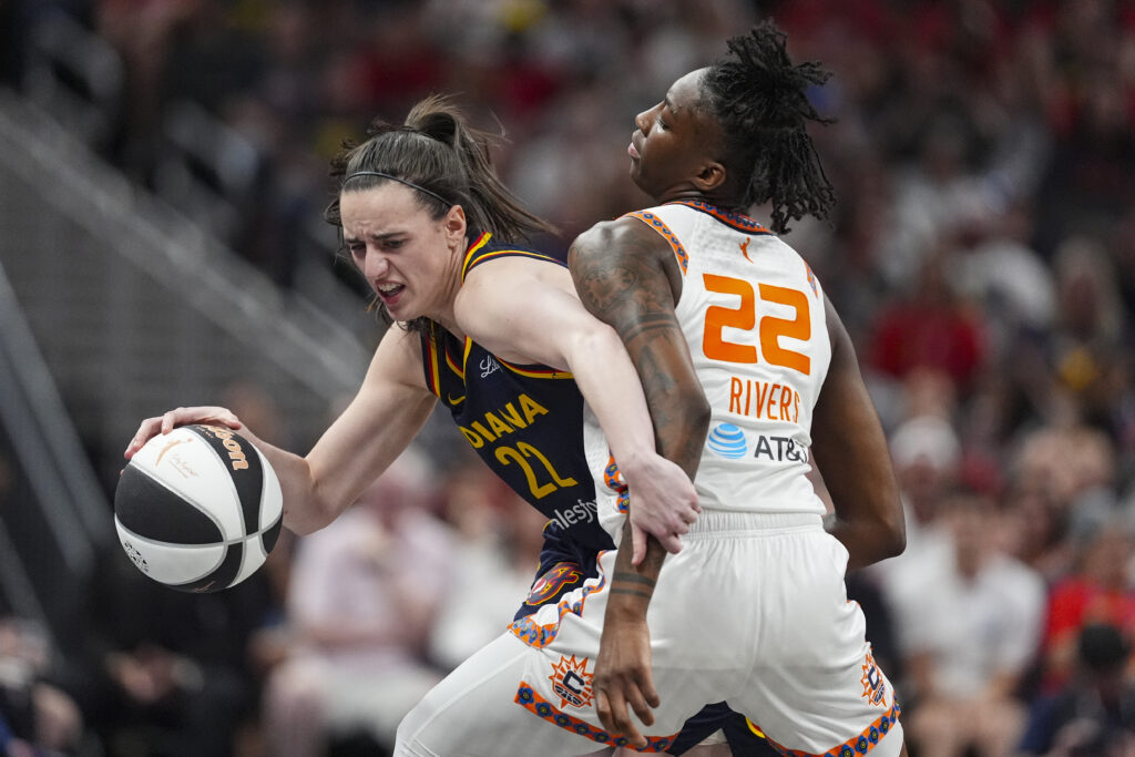 Indiana Fever guard Caitlin Clark (22) tries to get past Connecticut Sun guard Saniya Rivers (22) in the second half of a WNBA basketball game in Indianapolis, Tuesday, June 17, 2025.