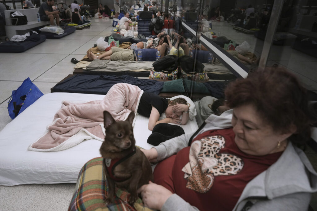 People take shelter in an underground metro station as a precaution against possible Iran missile attacks, in Ramat Gan, near Tel Aviv, Israel, Tuesday, June 17, 2025.