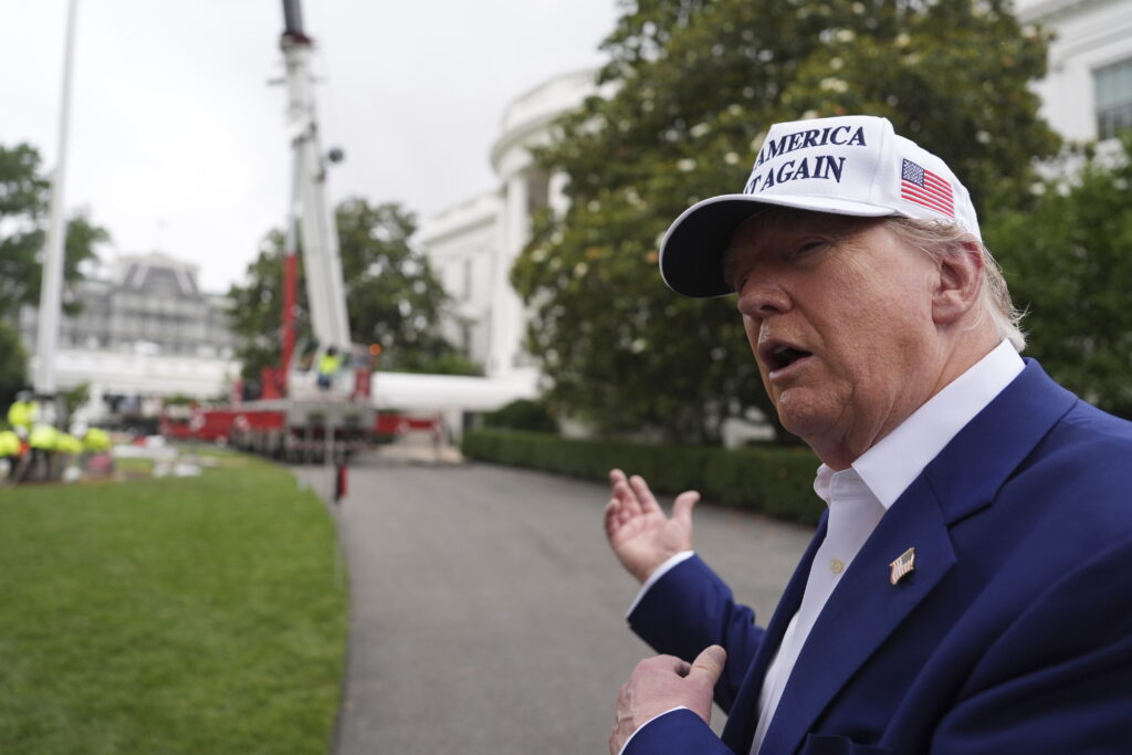 President Donald Trump speaks as a flag pole is installed on the South Lawn of the White House, Wednesday, June 18, 2025, in Washington.