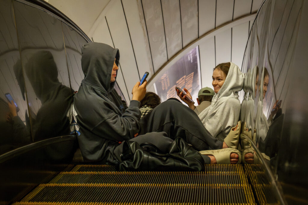 People rest in a metro station, being used as a bomb shelter, during a Russian drones attack in Kyiv, Ukraine, early Tuesday, June 10, 2025.