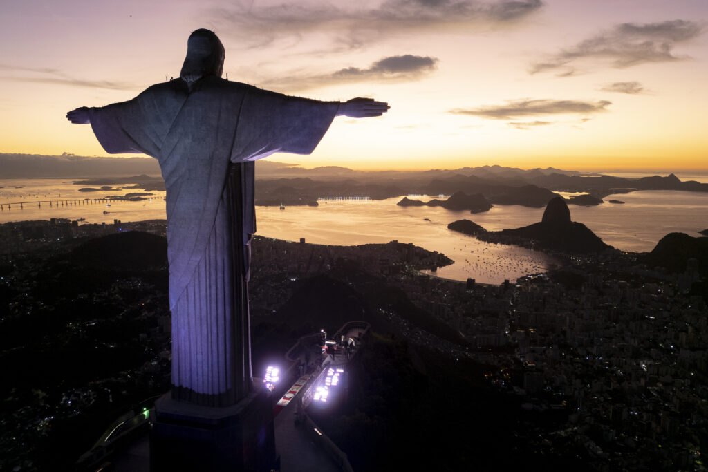 The Christ the Redeemer statue stands over Rio de Janeiro before a morning Mass celebrating the Catholic holiday of Corpus Christi is held at the statue, Thursday, June 19, 2025