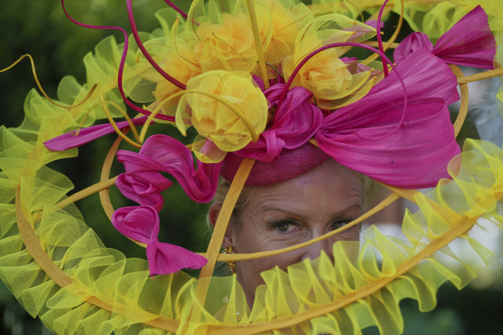 Vivienne Jenner wears a large ribbon based hat as she poses for photographers on the third day of the Royal Ascot horse race meeting, traditionally called Ladies Day, at Ascot, England, Thursday, June 19, 2025.