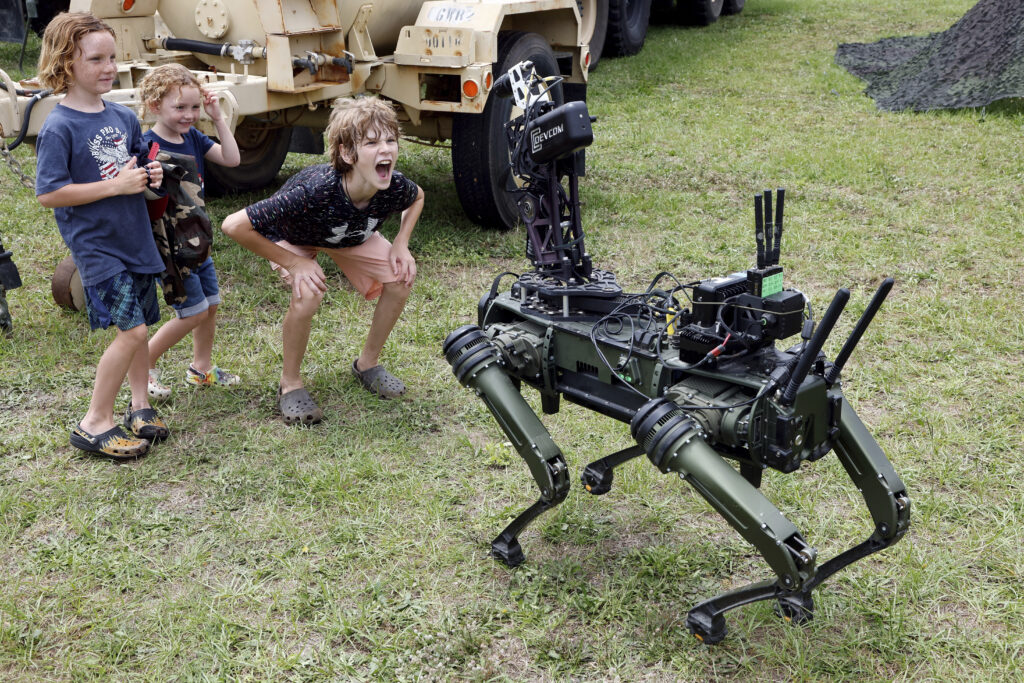 "Lone Wolf" a military robotic dog interacts with visitors at the America 250 Celebration at Fort Bragg in Fayetteville, N.C., Tuesday, June 10, 2025.