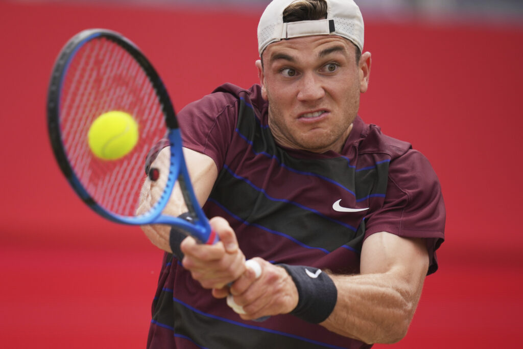 Britain's Jack Draper plays a return to Brandon Nakashima of the United States, during the quarterfinal match of the Queen's Club Championships tennis tournament in London, Friday, June 20, 2025.