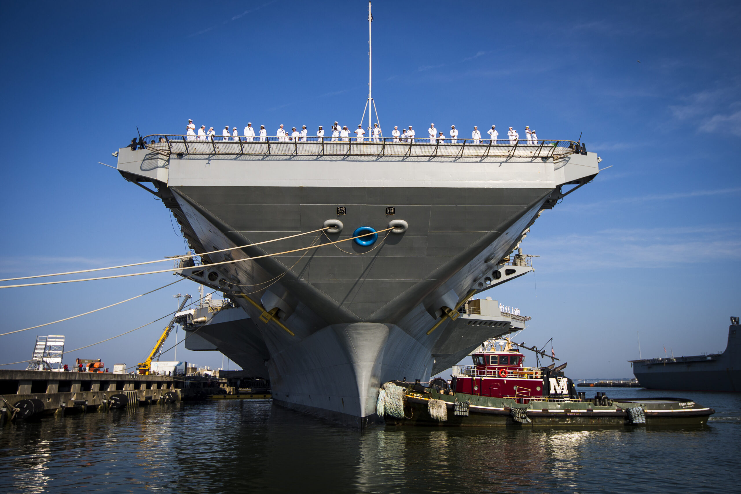 Sailors line up on flight deck as the USS Gerald R. Ford aircraft carrier leaves Naval Station Norfolk, Tuesday, June 24, 2025, in Norfolk, Va.