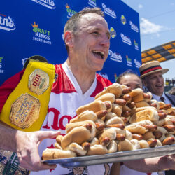 Joey Chestnut, winner of the 2021 Nathan's Famous Fourth of July International Hot Dog-Eating Contest, poses for photos in Coney Island's Maimonides Park, July 4, 2021, in Brooklyn. AP Photo/Brittainy Newman, File