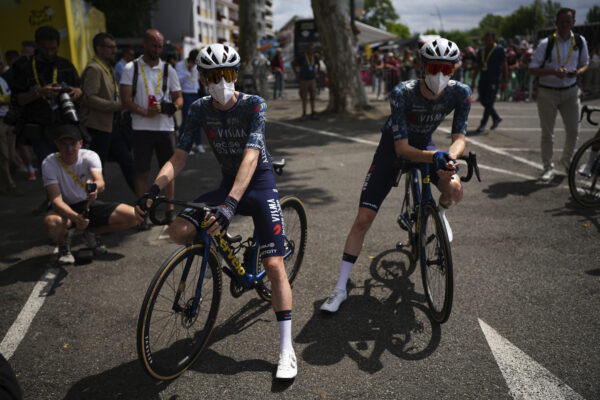 Denmark's Jonas Vingegaard, left, and teammate Matteo Jorgenson, of the U.S., wear face masks to protect themselves from the Corona virus prior to the start of the fourteenth stage of the Tour de France cycling race over 151.9 kilometers (94.4 miles) with start in Pau and finish in Saint-Lary-Soulan Pla d'Adet, France, July 13, 2024. AP Photo/Daniel Cole, File