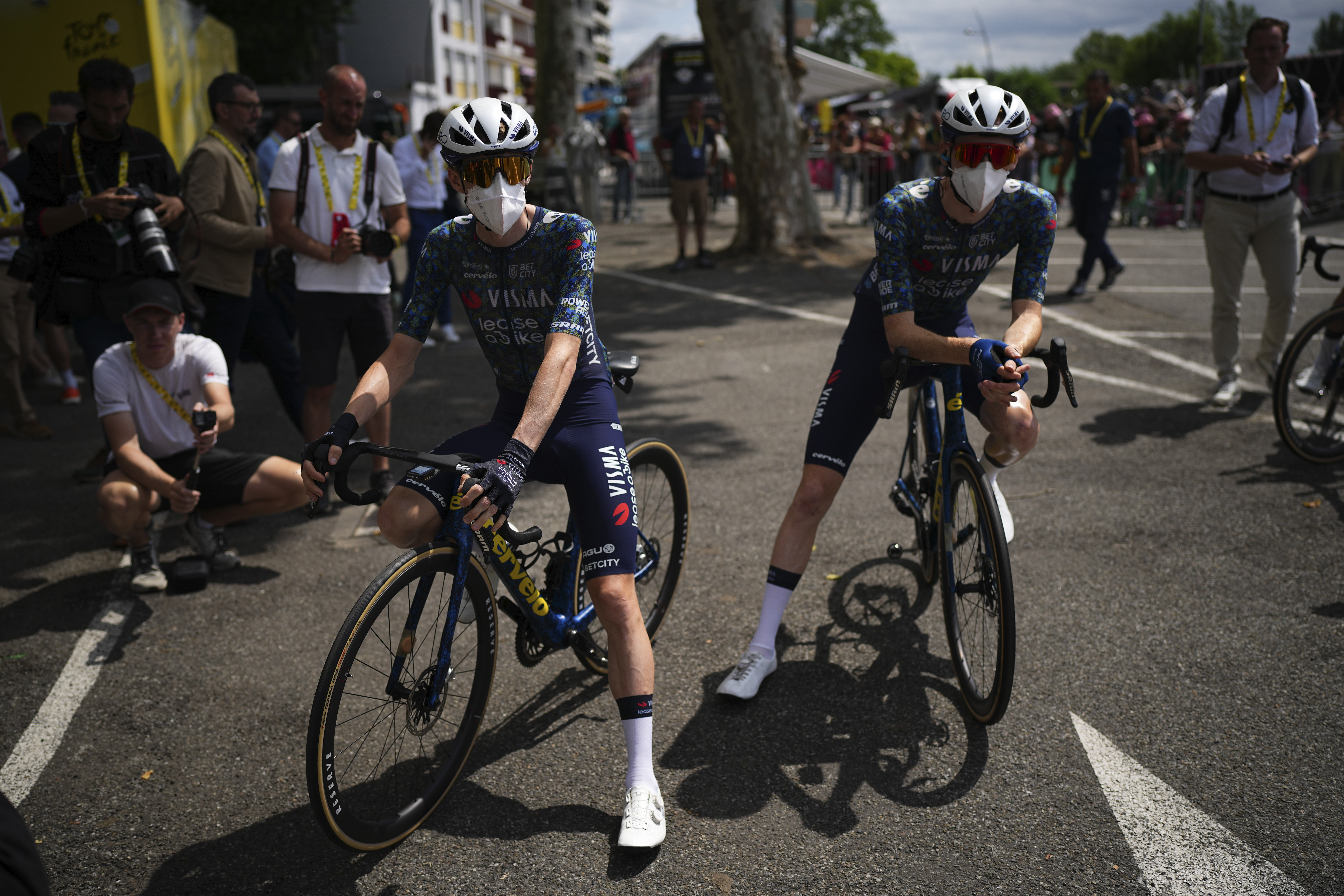Denmark's Jonas Vingegaard, left, and teammate Matteo Jorgenson, of the U.S., wear face masks to protect themselves from the Corona virus prior to the start of the fourteenth stage of the Tour de France cycling race over 151.9 kilometers (94.4 miles) with start in Pau and finish in Saint-Lary-Soulan Pla d'Adet, France, July 13, 2024. AP Photo/Daniel Cole, File