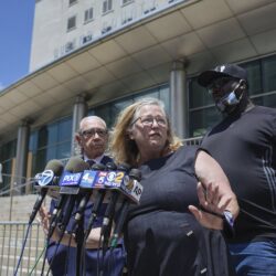 Lori Zeno (center), the former executive director of Queens Defenders, was arraigned on fraud charges Wednesday after prosecutors said she stole tens of thousands of dollars from the organization she founded. Photo: Kevin Hagen/AP