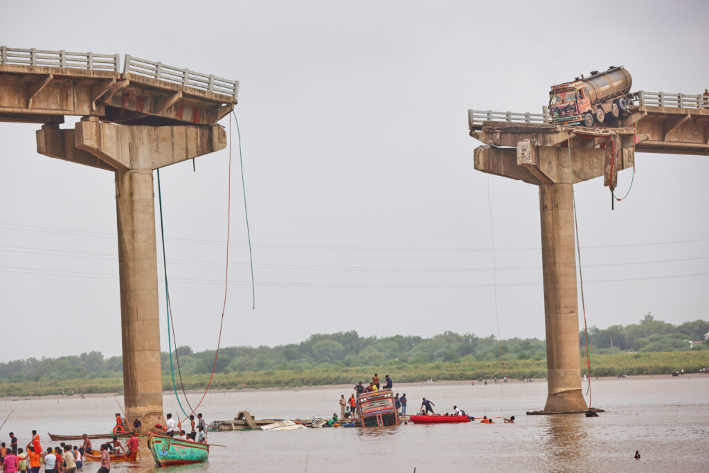 Rescuers and locals look for survivors after several vehicles fell into a river following the collapse of a portion of a bridge in Mujpur near Vadodara in the Indian state of Gujarat, Wednesday, July 9, 2025.