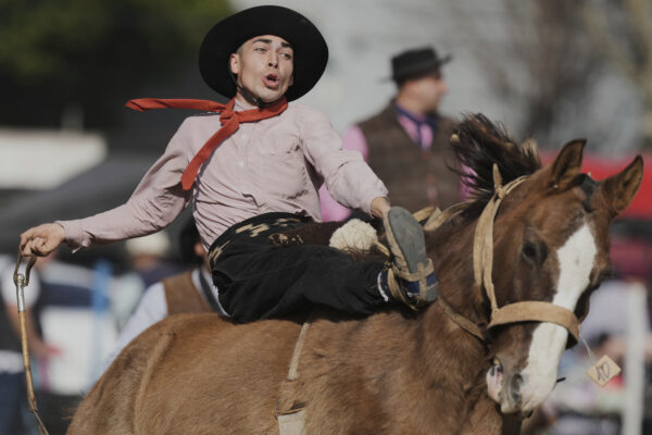 Sebastian Campos rides a horse at a rodeo celebrating Independence Day in San Isidro, Argentina, Wednesday, July 9, 2025.