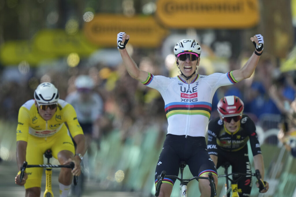 Slovenia's Tadej Pogacar, right, celebrates as he crosses the finish line to win the fourth stage of the Tour de France cycling race over 172.2 kilometers (107 miles) with start in Amiens and finish in Rouen, France, Tuesday, July 8, 2025.
