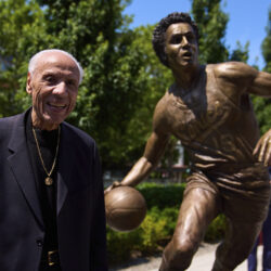 Former NBA basketball player and coach Lenny Wilkens poses for a photo with his statue after its unveiling outside of Climate Pledge Arena, Saturday, June 28, 2025, in Seattle. AP Photo/Lindsey Wasson