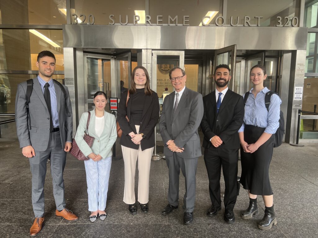 Judge Mark Partnow alongside Liakas Law’s summer 2025 interns. Brooklyn Eagle photo by Wayne Daren Schneiderman