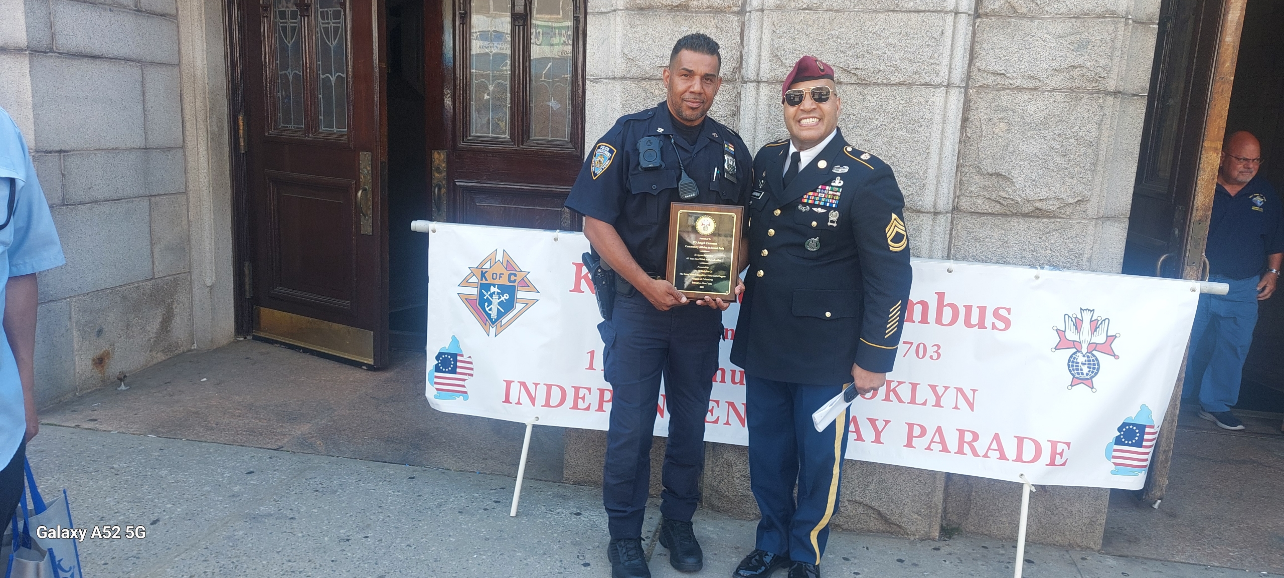 Officer Carmona with the award outside Our Lady of Perpetual Help. Photo courtesy of Officer Angel Carmona