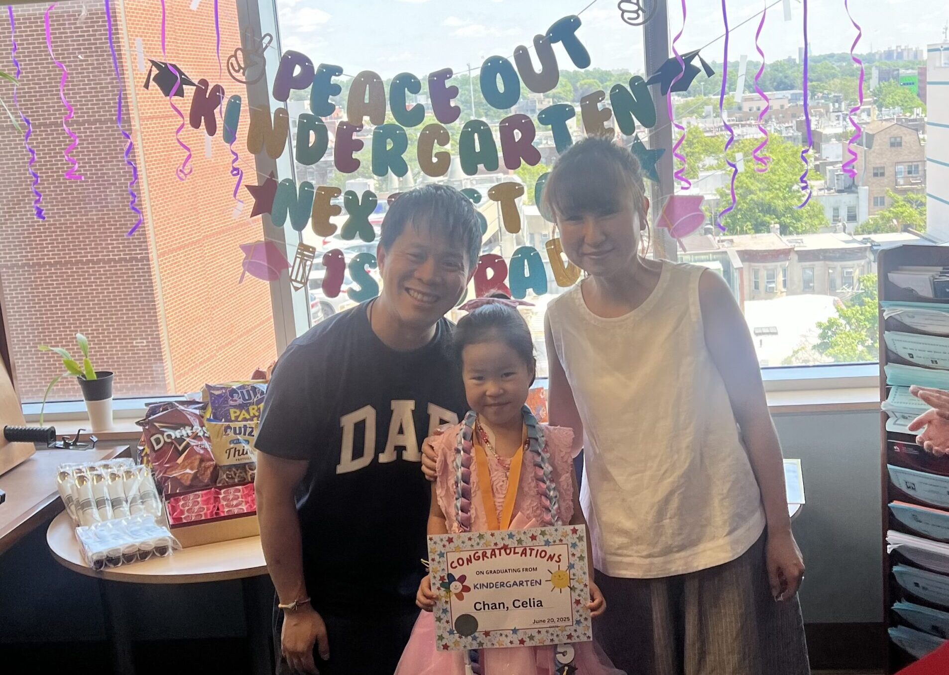Five-year-old Celia Chan receives her diploma during a surprise graduation ceremony just for her at Maimonides Medical Center as she recovers from pneumonia. Photo courtesy of Maimonides Health