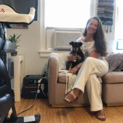 Upper West Side resident Addy Spiller and her dog, Ranger, participated in a pilot program to charge her air conditioning unit with a portable battery unit, Aug. 6, 2025. Credit: Samantha Maldonado/THE CITY