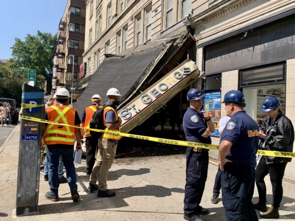 Personnel from the city’s Department of Buildings and Metropolitan Transit Authority examine the scene of a collapsed awning in front of the Hotel St. George on Sunday, Aug. 3 in Brooklyn Heights. Photo: Mary Frost/Brooklyn Eagle