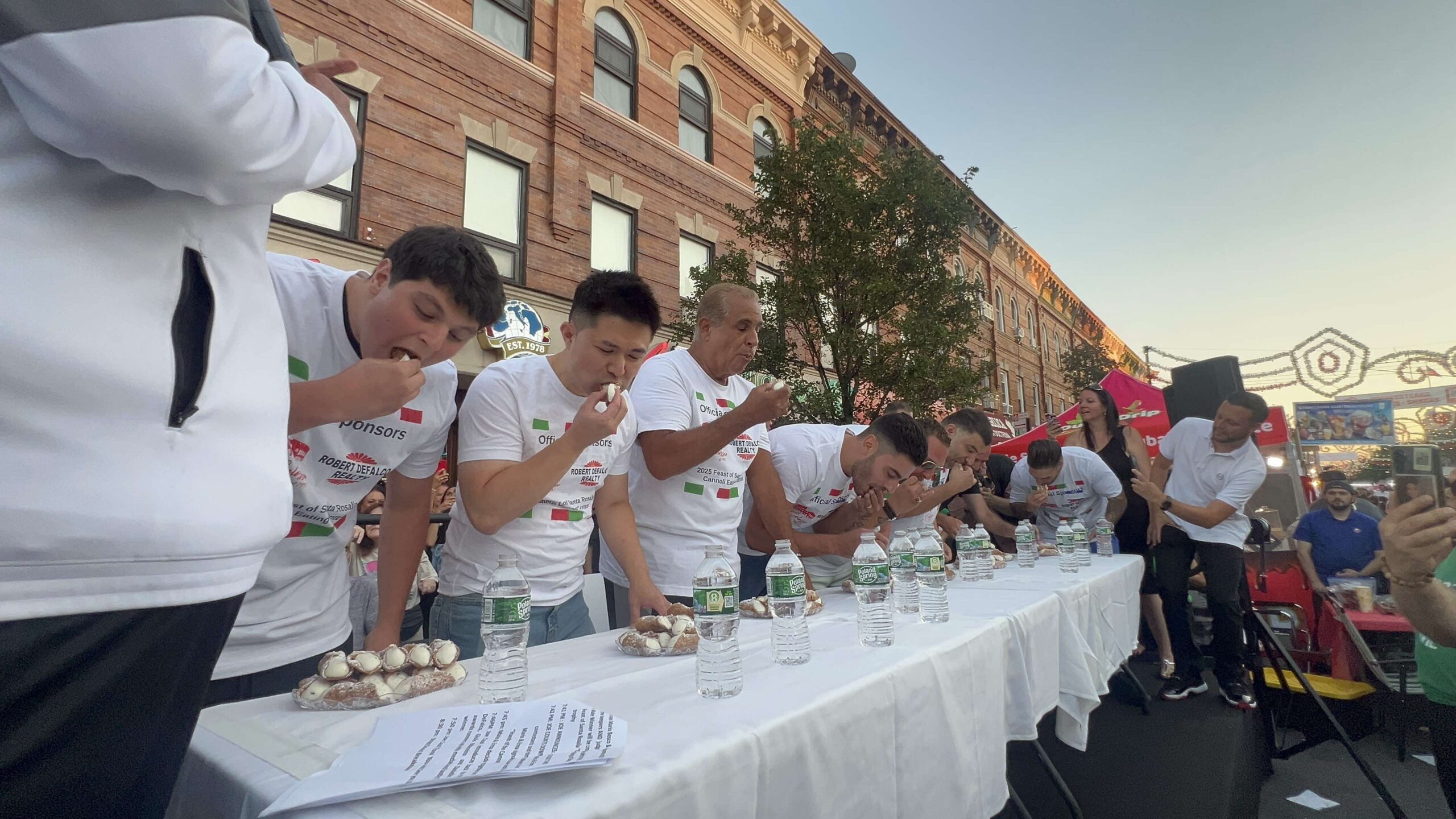 The annual cannoli eating contest underway in Bensonhurst. Photo courtesy of Jay Zhang