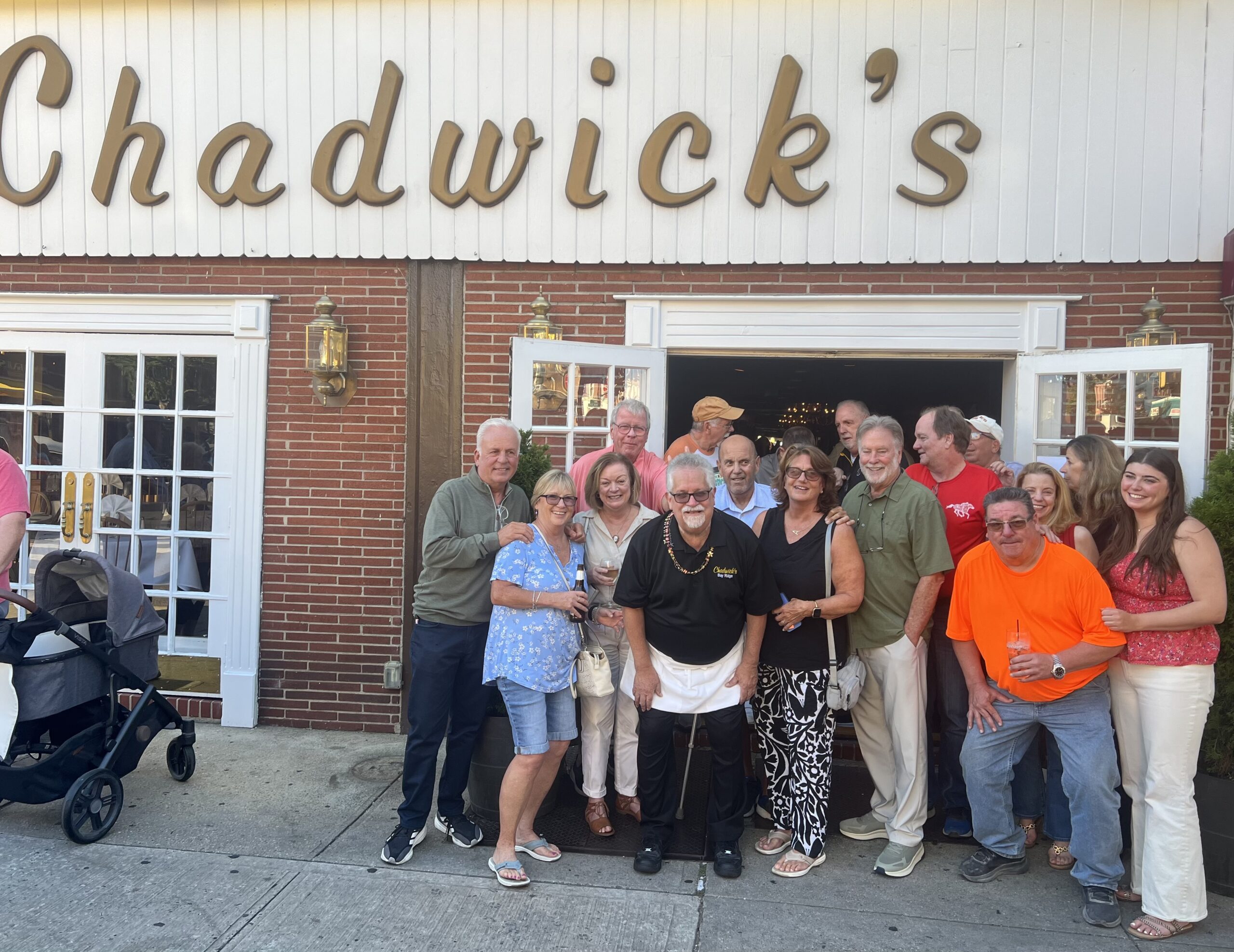Roy DeLorenzo, Chadwick’s management and customers pose for the camera. Photo by Wayne Daren Schneiderman