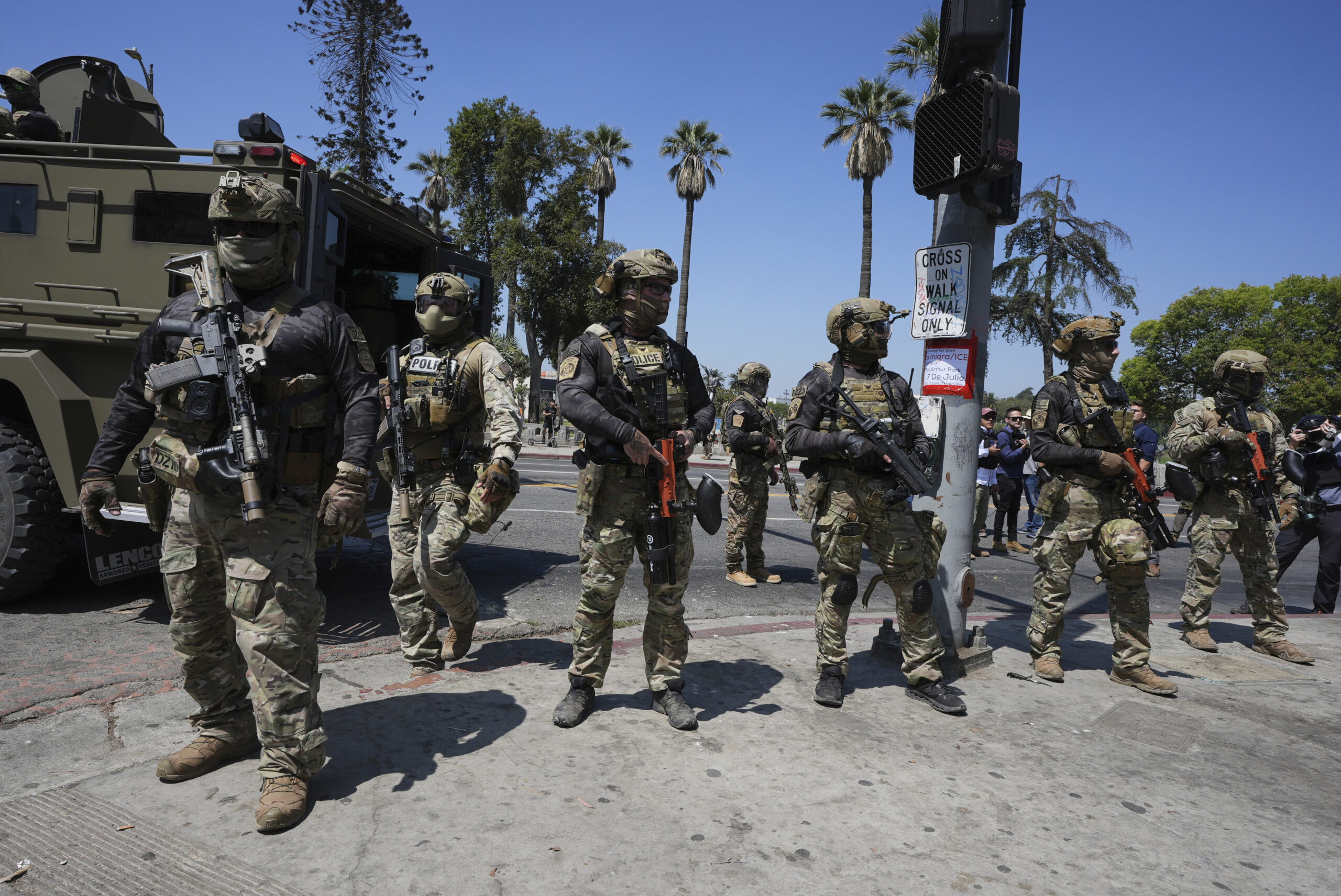 Federal agents stage at MacArthur Park, July 7, 2025, in Los Angeles. Photo: Damian Dovarganes/AP