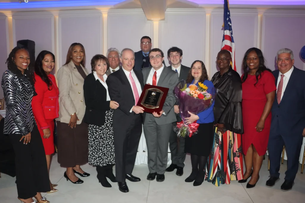From left: Assemblymember Monique Chandler-Waterman, District 58; Assemblymember Jaime Williams, District 59; Attorney General Letitia James; Sue Ann Partnow, Community Board 18 district manager; Hon. Frank Seddio; Jeffrey Miller, Esq., Brooklyn Brandeis Society president, alongside his family; Mitchell Partnow, top row; State Senator Roxanne Persaud; Brooklyn Democratic Party Chair Rodneyse Bichotte Hermelyn; and Brooklyn District Attorney Eric Gonzalez. Brooklyn Eagle photo by Mario Belluomo