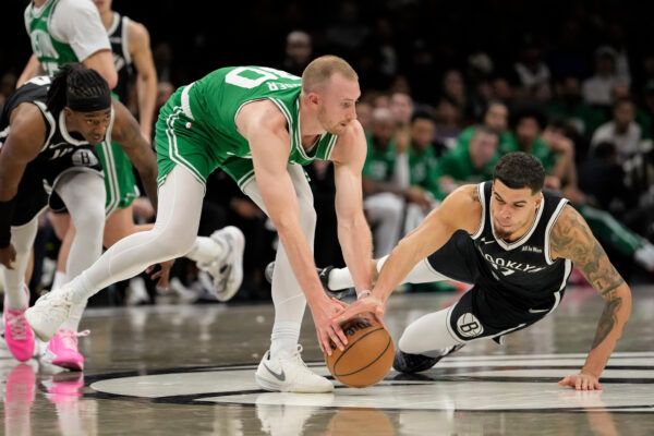 Boston Celtics forward Sam Hauser fights for control of the ball with Brooklyn Nets forward Michael Porter Jr. during the second half of an NBA basketball game, Tuesday, Nov. 18, 2025, in New York. (AP Photo/Yuki Iwamura)