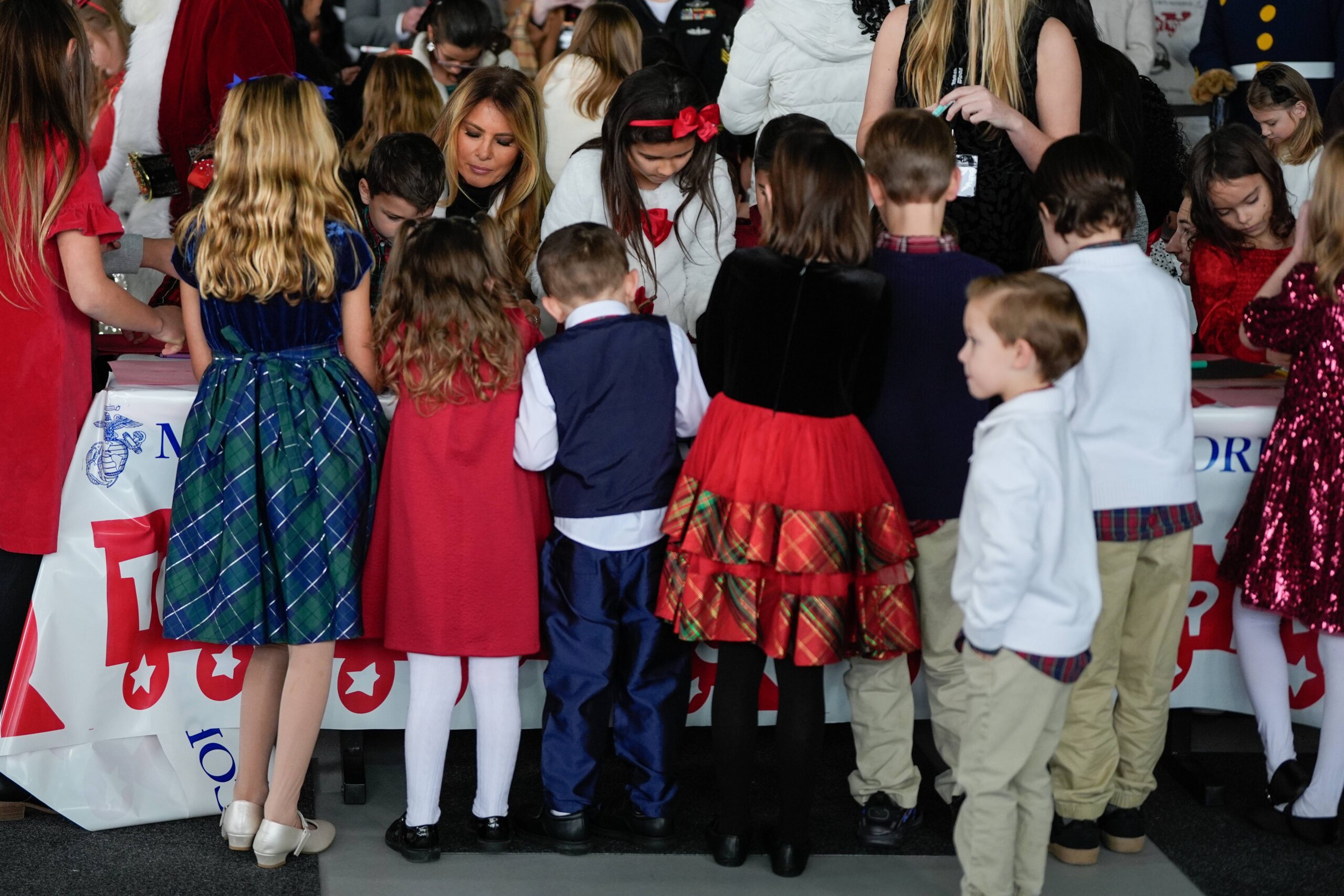 First lady Melania Trump writes holiday cards with kids during a Toys for Tots charity drive event at Marine Corps Base Quantico, Monday, Dec. 8, 2025, in Quantico, Va. Photo: Julia Demaree Nikhinson/AP