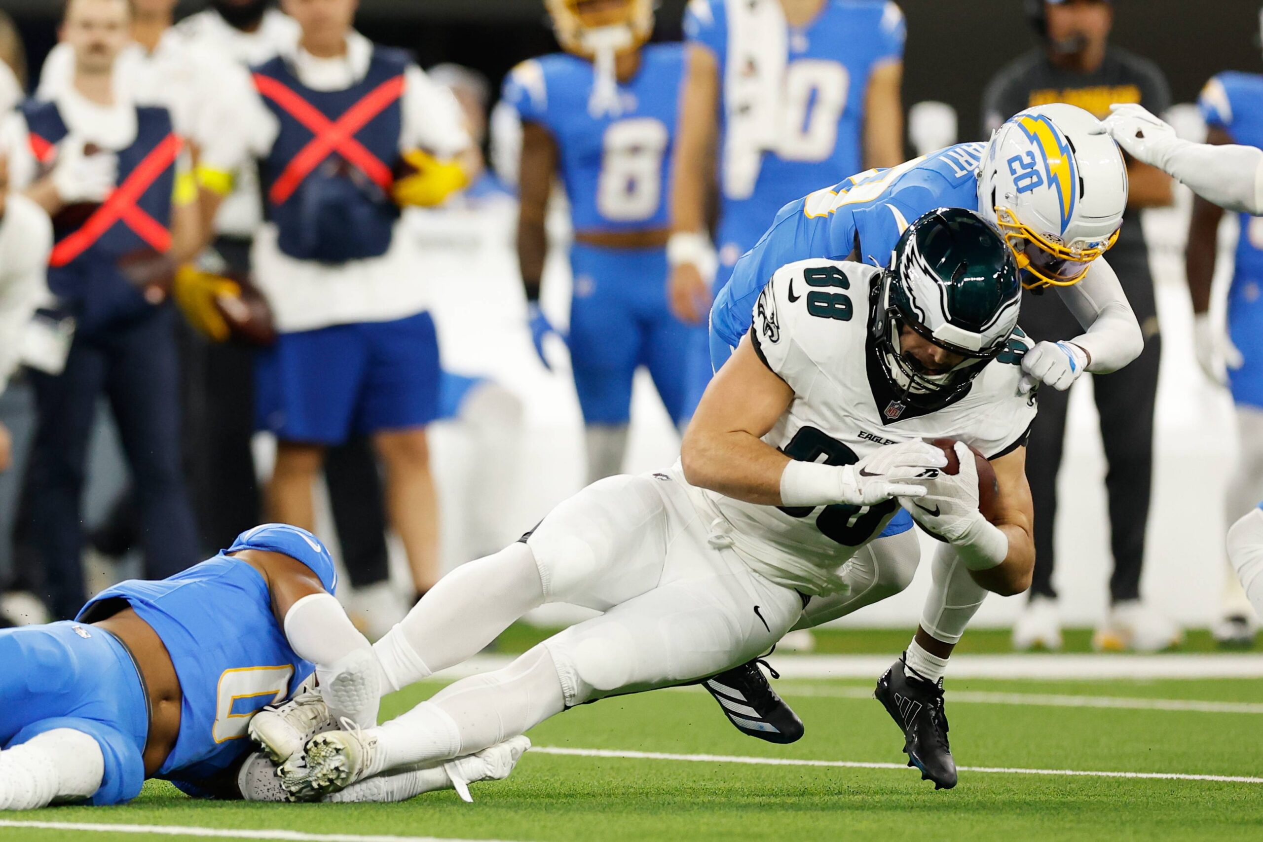 Philadelphia Eagles tight end Dallas Goedert (88) is tackled by Los Angeles Chargers cornerback Cam Hart (20) during the first half of an NFL football game Monday, Dec. 8, 2025, in Inglewood, Calif. Photo: Caroline Brehman/AP
