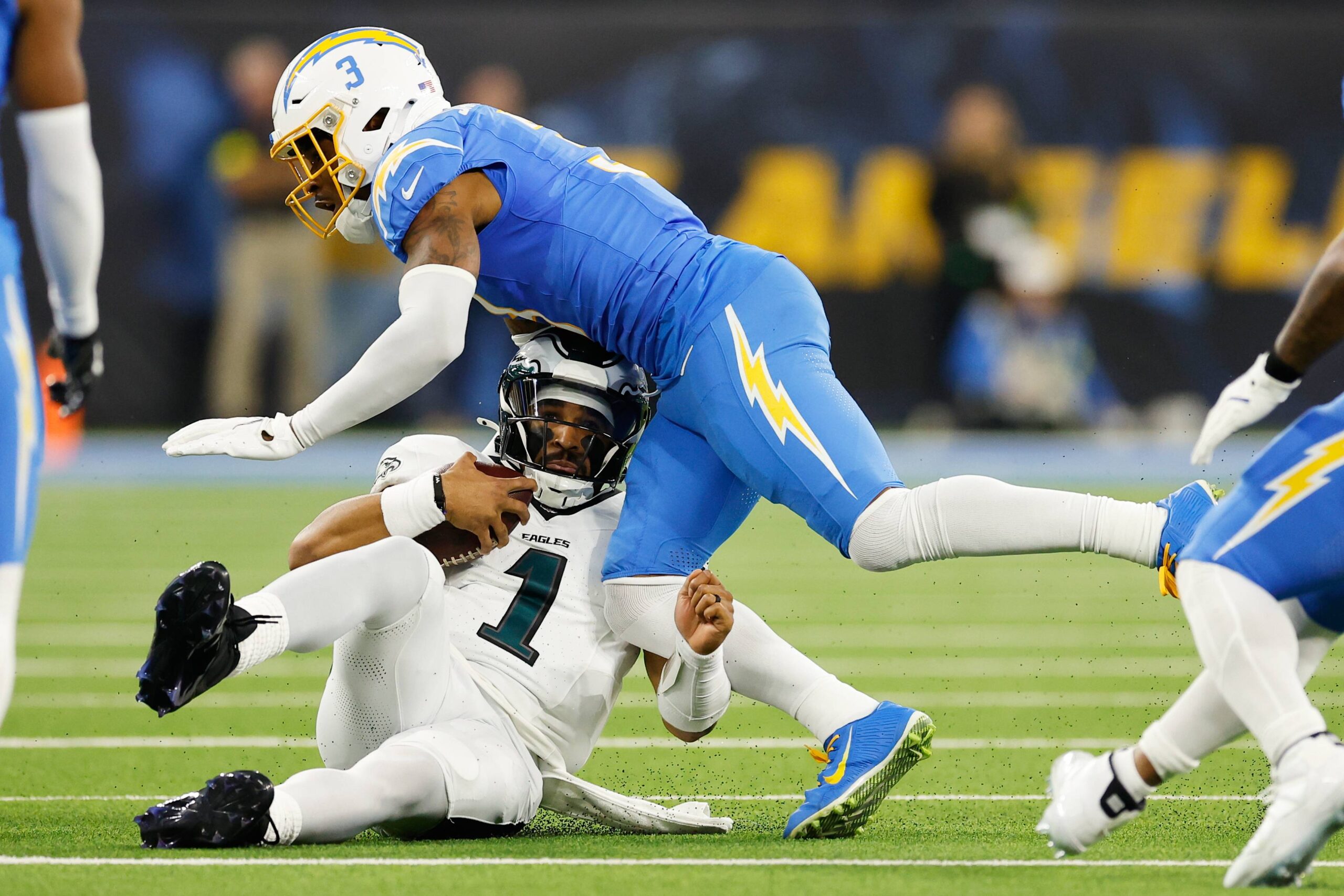 Philadelphia Eagles quarterback Jalen Hurts (1) slides under Los Angeles Chargers free safety Derwin James (3) during the first half of an NFL football game Monday, Dec. 8, 2025, in Inglewood, Calif. Photo: Caroline Brehman/AP