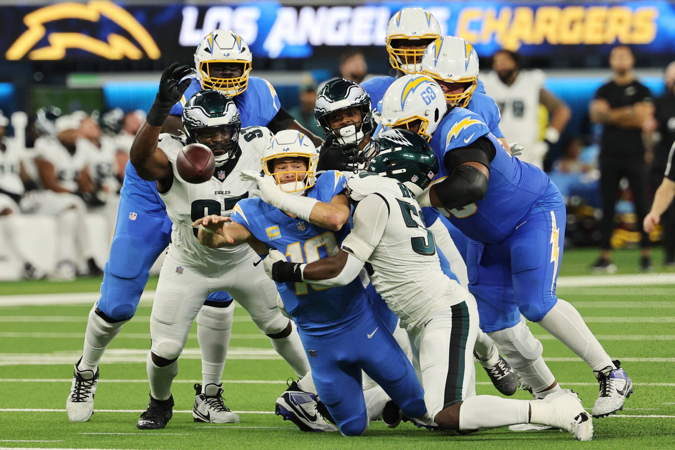 Los Angeles Chargers quarterback Justin Herbert (10) throws as he tackled by Philadelphia Eagles linebacker Jalyx Hunt during the first half of an NFL football game Monday, Dec. 8, 2025, in Inglewood, Calif. Photo: Kevork Djansezian/AP
