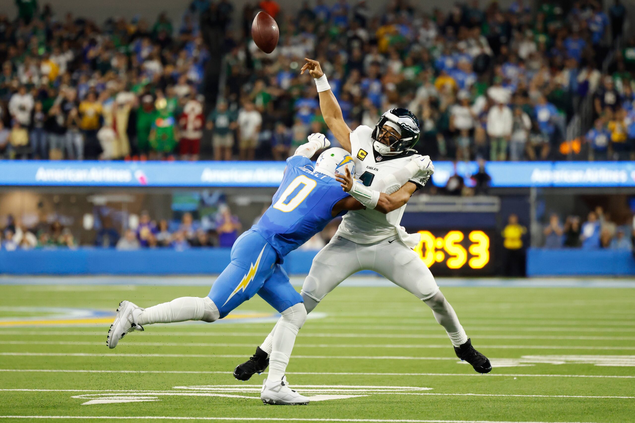 Philadelphia Eagles quarterback Jalen Hurts (1) throws as he is tackled by Los Angeles Chargers linebacker Daiyan Henley (0) during the first half of an NFL football game Monday, Dec. 8, 2025, in Inglewood, Calif. Photo: Caroline Brehman/AP