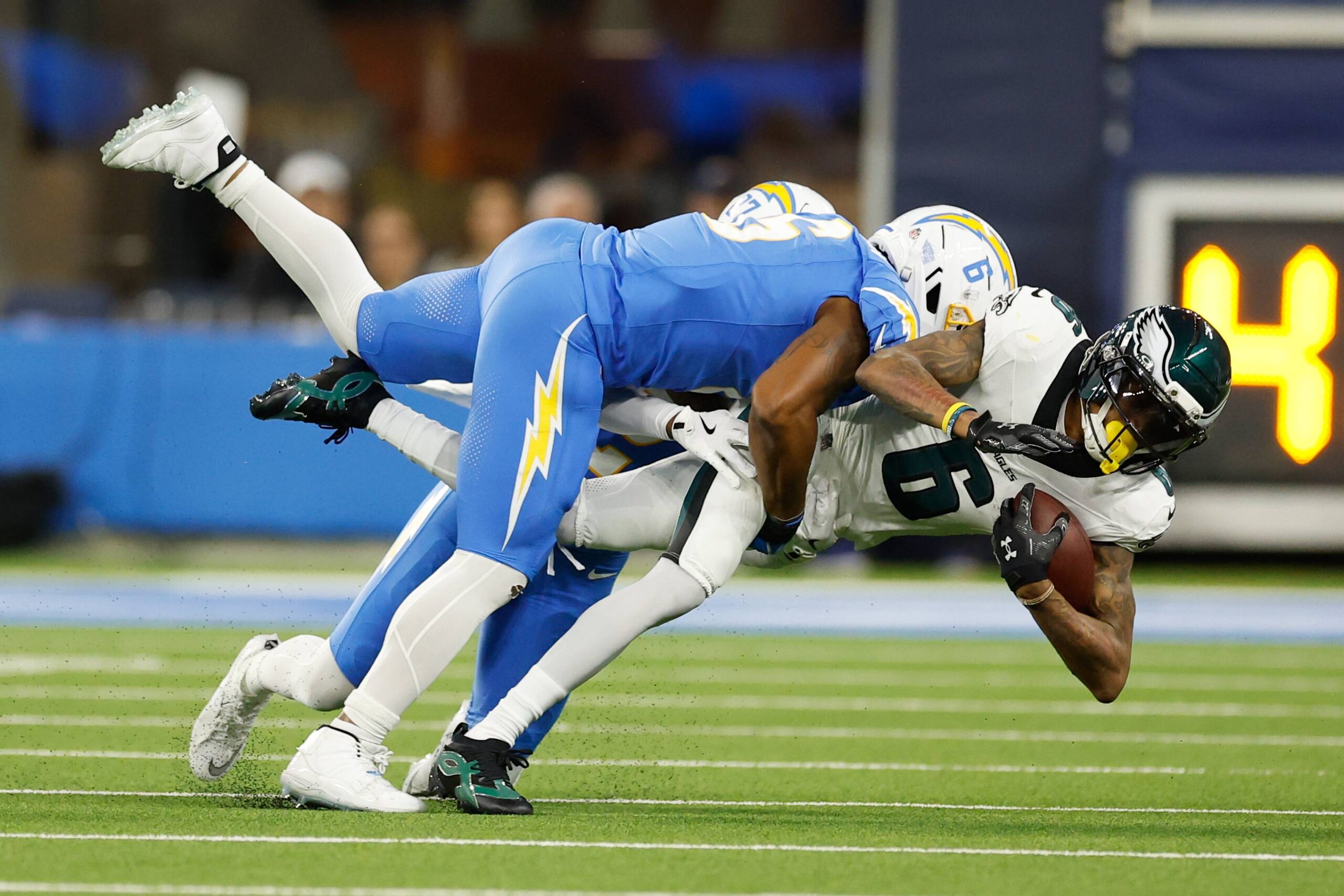 Philadelphia Eagles wide receiver Devonta Smith, bottom, is tackled by Los Angeles Chargers middle linebacker Denzel Perryman (6) during the second half of an NFL football game Monday, Dec. 8, 2025, in Inglewood, Calif. Photo: Caroline Brehman/AP