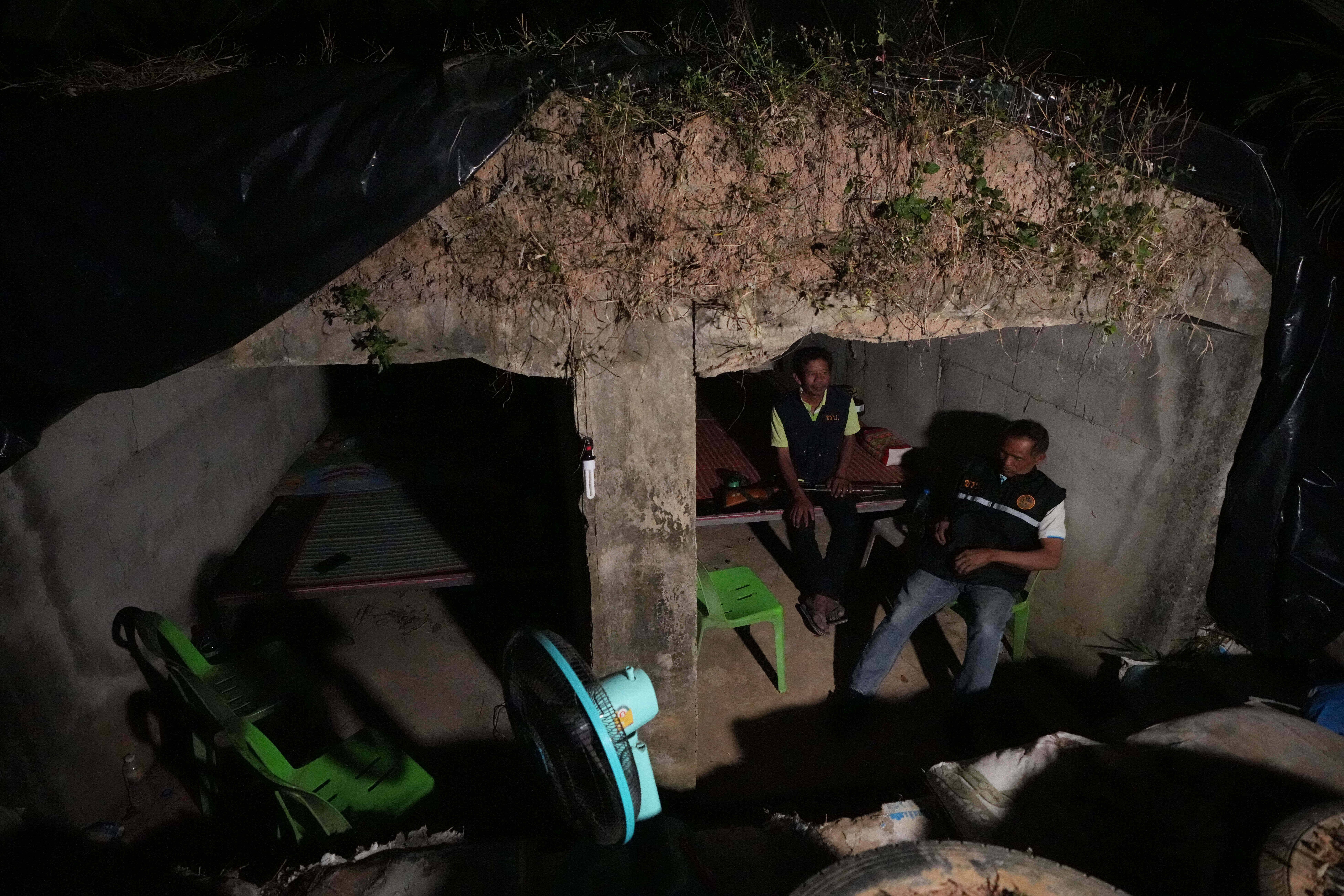 Village security volunteers sit inside shelter during Thai and Cambodian soldiers clashes in Surin province, Thailand, Tuesday, Dec. 9, 2025. Photo: Sakchai Lalit/AP