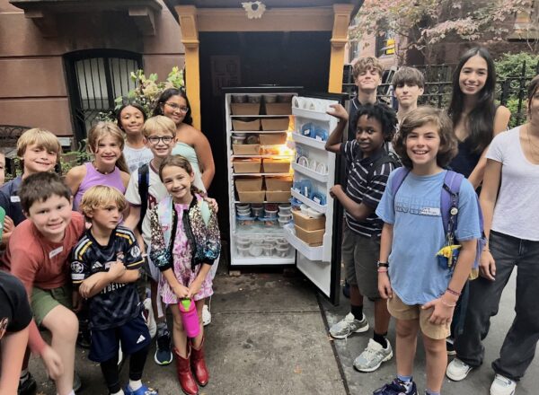 This January photo shows young volunteers with The Service Collective next to the Brooklyn Heights Community Fridge. Photo: Andrea Kapner