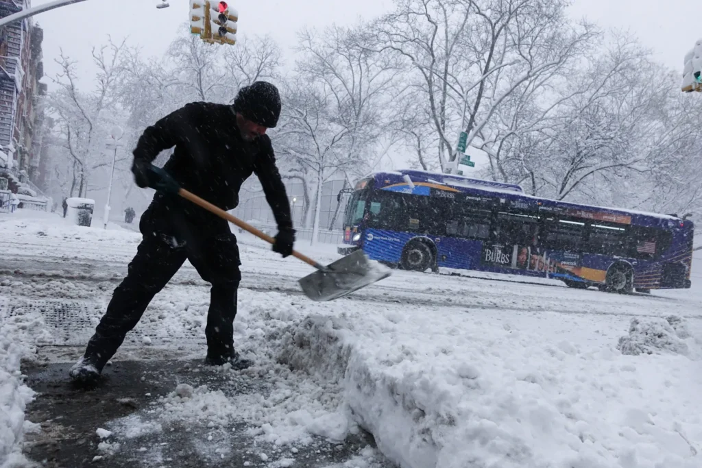 Ricardo Hernandez shovels outside studio where he works in the East village during a blizzard, Feb. 23, 2026. Credit: Gwynne Hogan/THE CITY