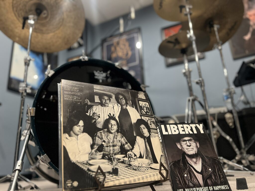 The back cover of the 1977 Billy Joel album “The Stranger,” featuring Liberty DeVitto, top right, and Joel, bottom right, and DeVitto’s 2020 memoir, “Liberty: Life, Billy and the Pursuit of Happiness.” Photo by Steve Milone