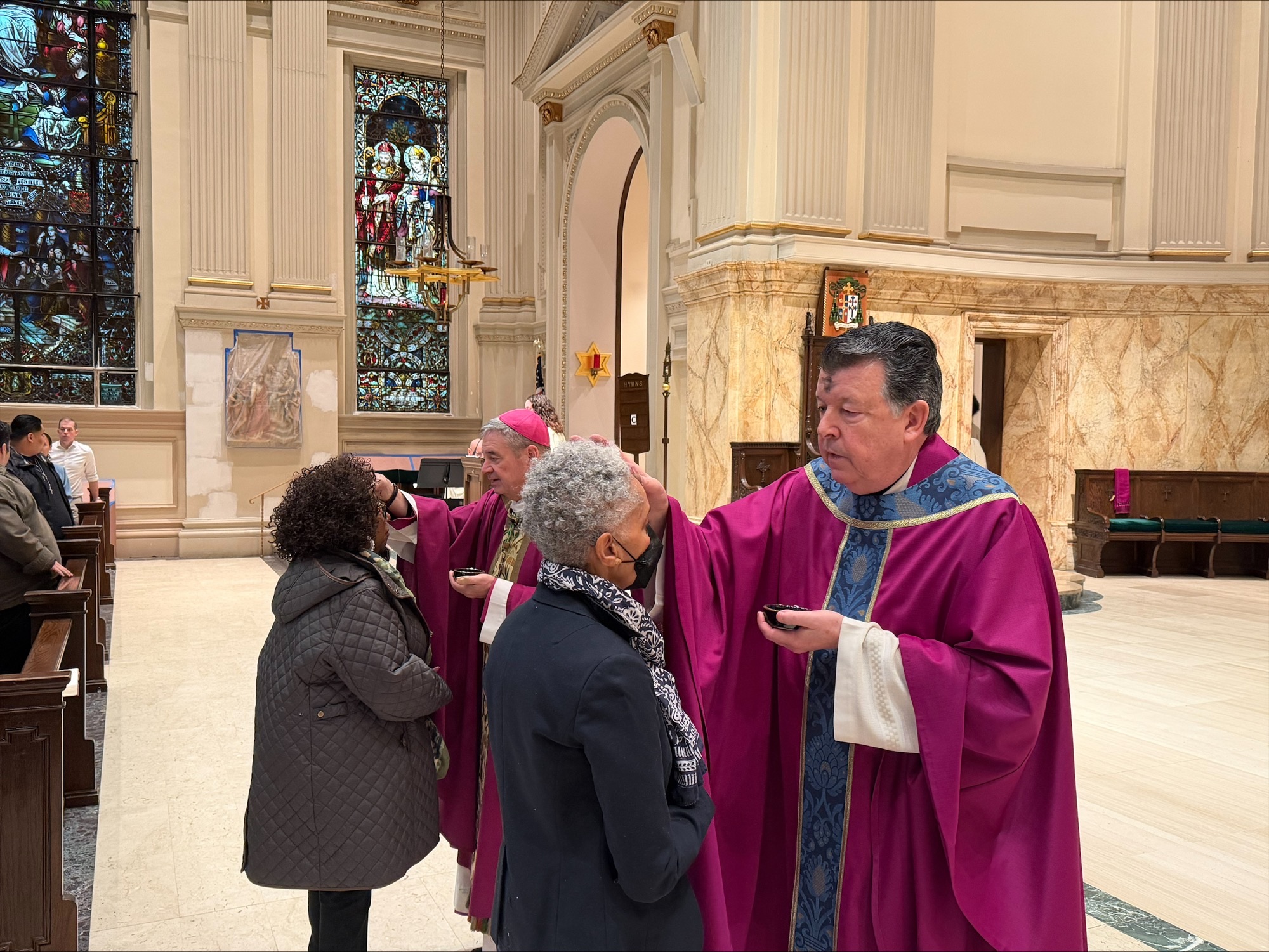 Monsignor Joseph Grimaldi places ashes on the foreheads of worshipers at St. James Cathedral. Photo courtesy John Quaglione/Diocese of Brooklyn