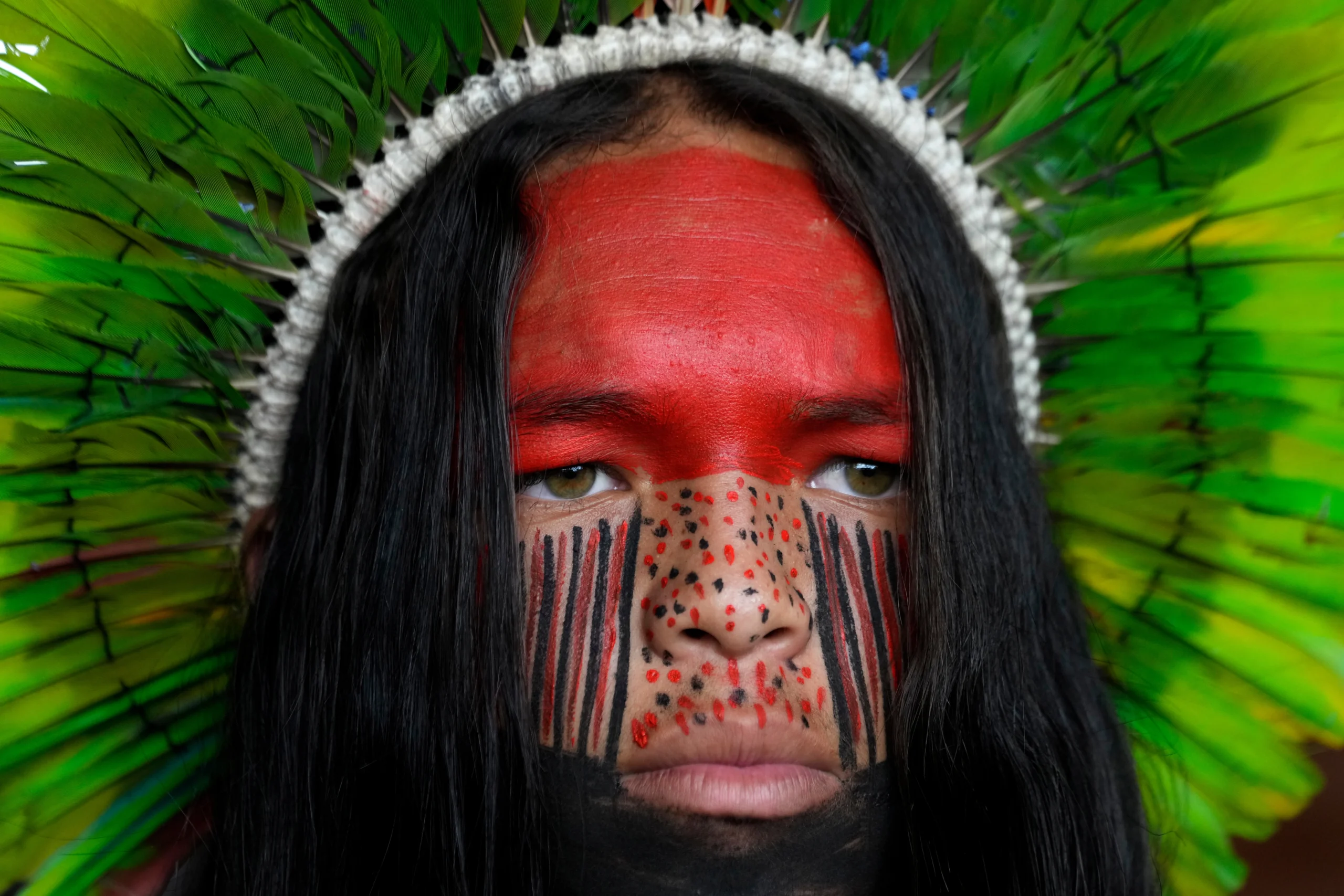 BRAZIL — Dramatic and colorful statements as Indigenous mobilization grows in Brazil: A Pataxo man looks on before a march at the Acampamento Terra Livre 2026, an Indigenous mobilization focused on land rights and environmental protection, in Brasilia, Brazil, Thursday, April 9, 2026. Photo: Eraldo Peres/AP