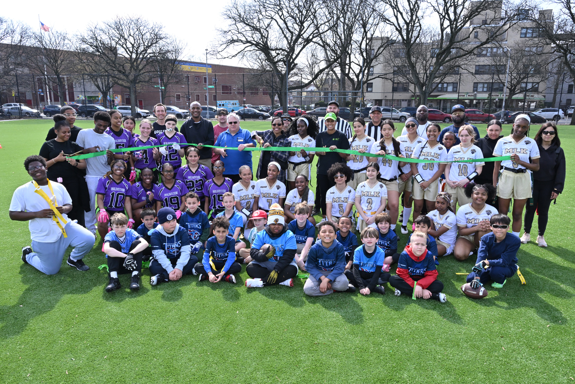City Councilmember Rita Joseph, NYC Parks Brooklyn Borough Parks Commissioner Martin Maher and PPA President Morgan Monaco, along with coaches and players from the United Sports Youth League, cut the ribbon at the Prospect Park Parade Ground’s newly restored Field 9 on April 4, 2026. Photo: Paul Martinka/Prospect Park Alliance.