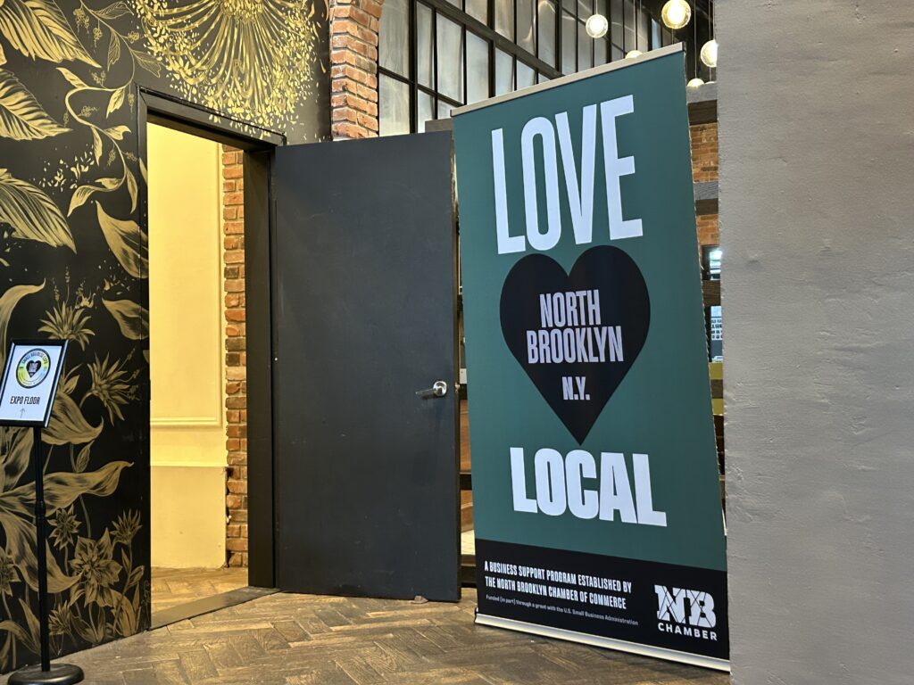 The door to the expo floor on Tuesday. Greenpoint Glam, a local small business, offered free headshots to local business owners. Photo: Ella Spungen/Brooklyn Eagle