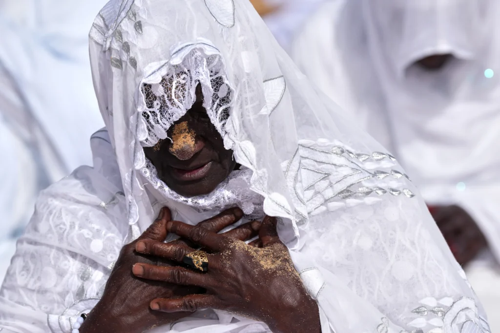 SENEGAL — Tracks from sand are clear record of devotion: A Muslim woman performs Eid al-Adha prayers in the Yoff neighborhood of Dakar, Thursday, May 28, 2026. Photo: Misper Apawu/AP