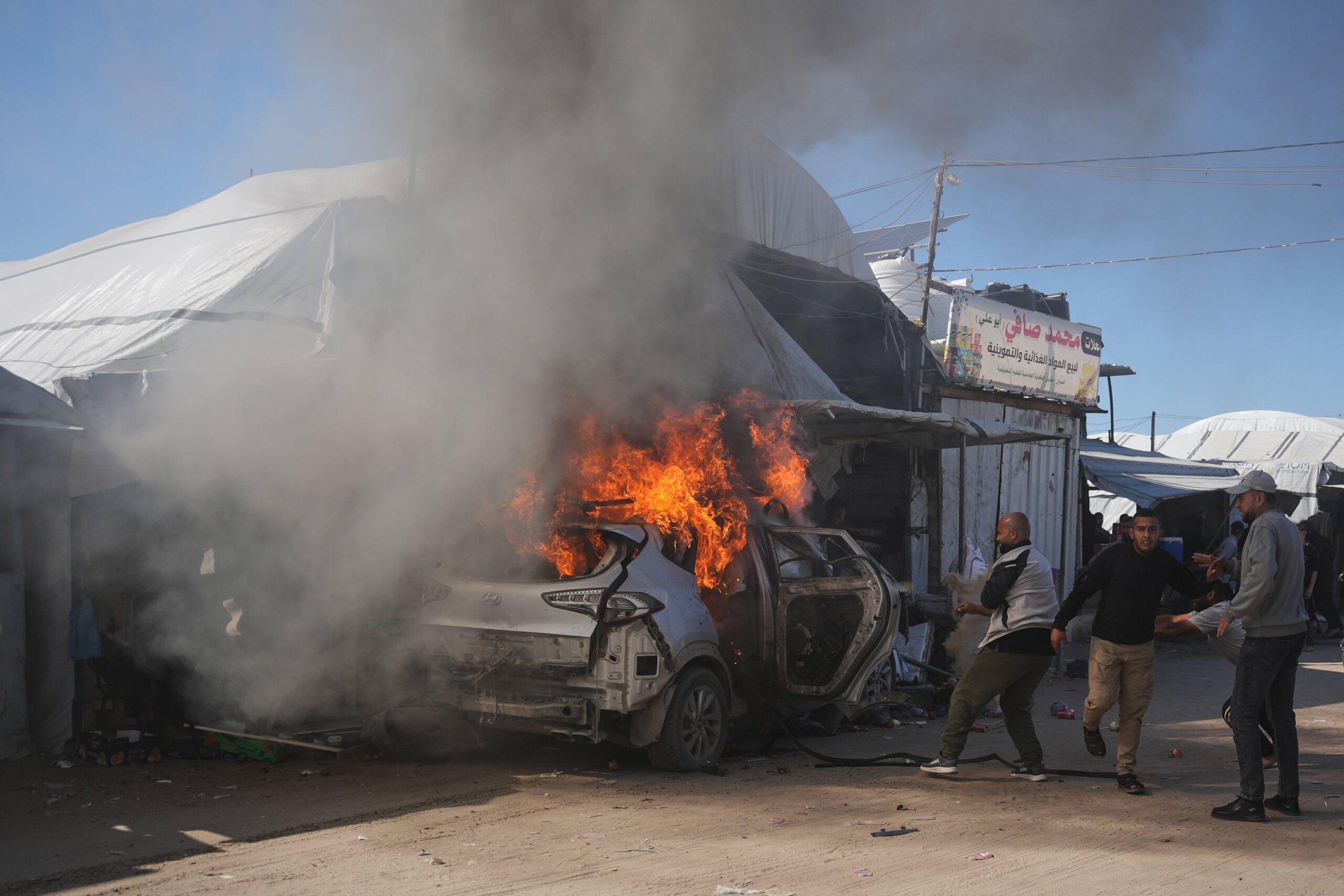 Palestinians gather around a vehicle struck by an Israeli airstrike in Khan Younis, southern Gaza Strip, Wednesday, May 6, 2026. Photo: Abdel Kareem Hana/AP