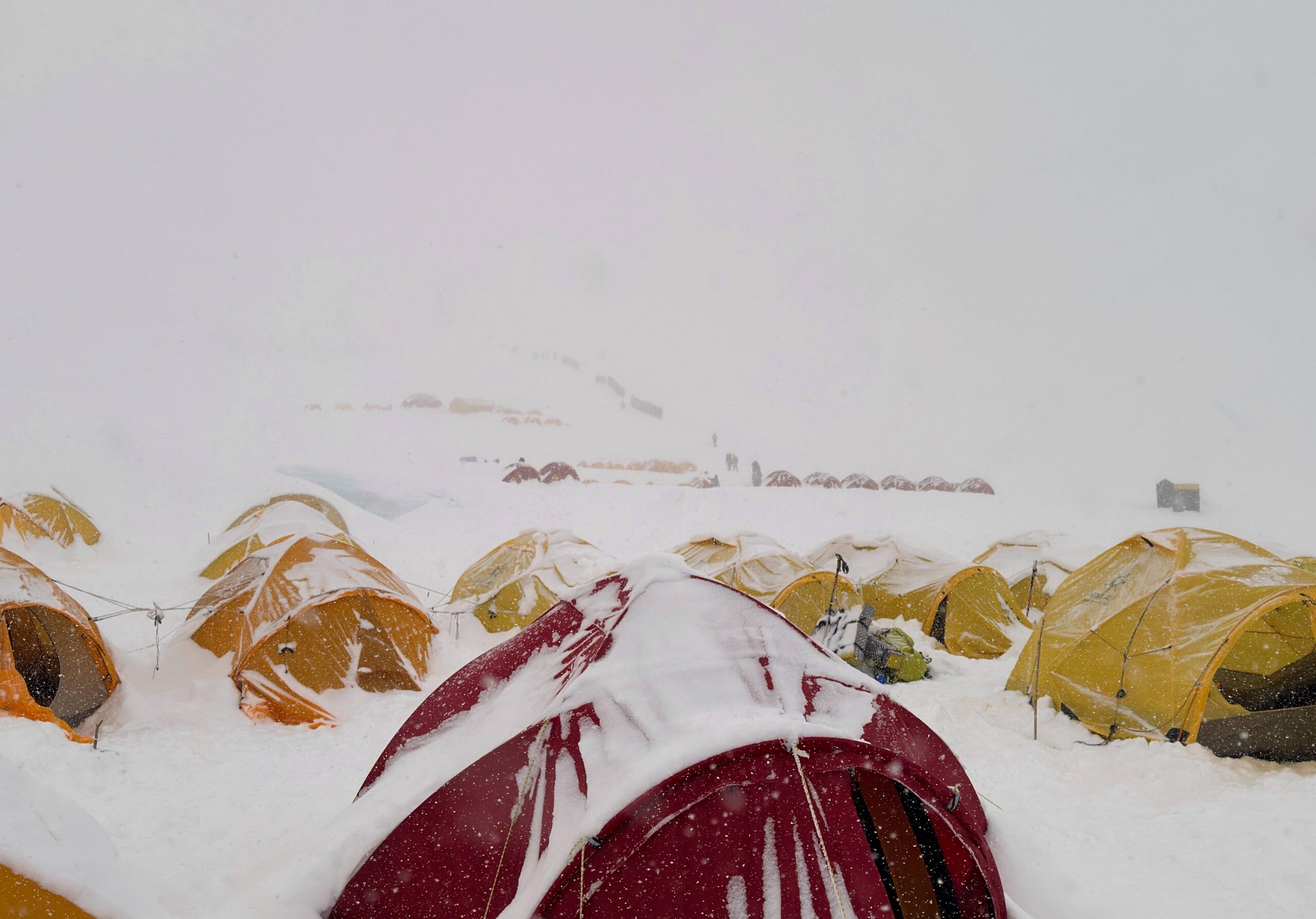 Snow covers tents during a period of inclement weather at the Everest Base Camp, Nepal, Thursday, May 7, 2026. Photo: Pasang Rinzee Sherpa/AP