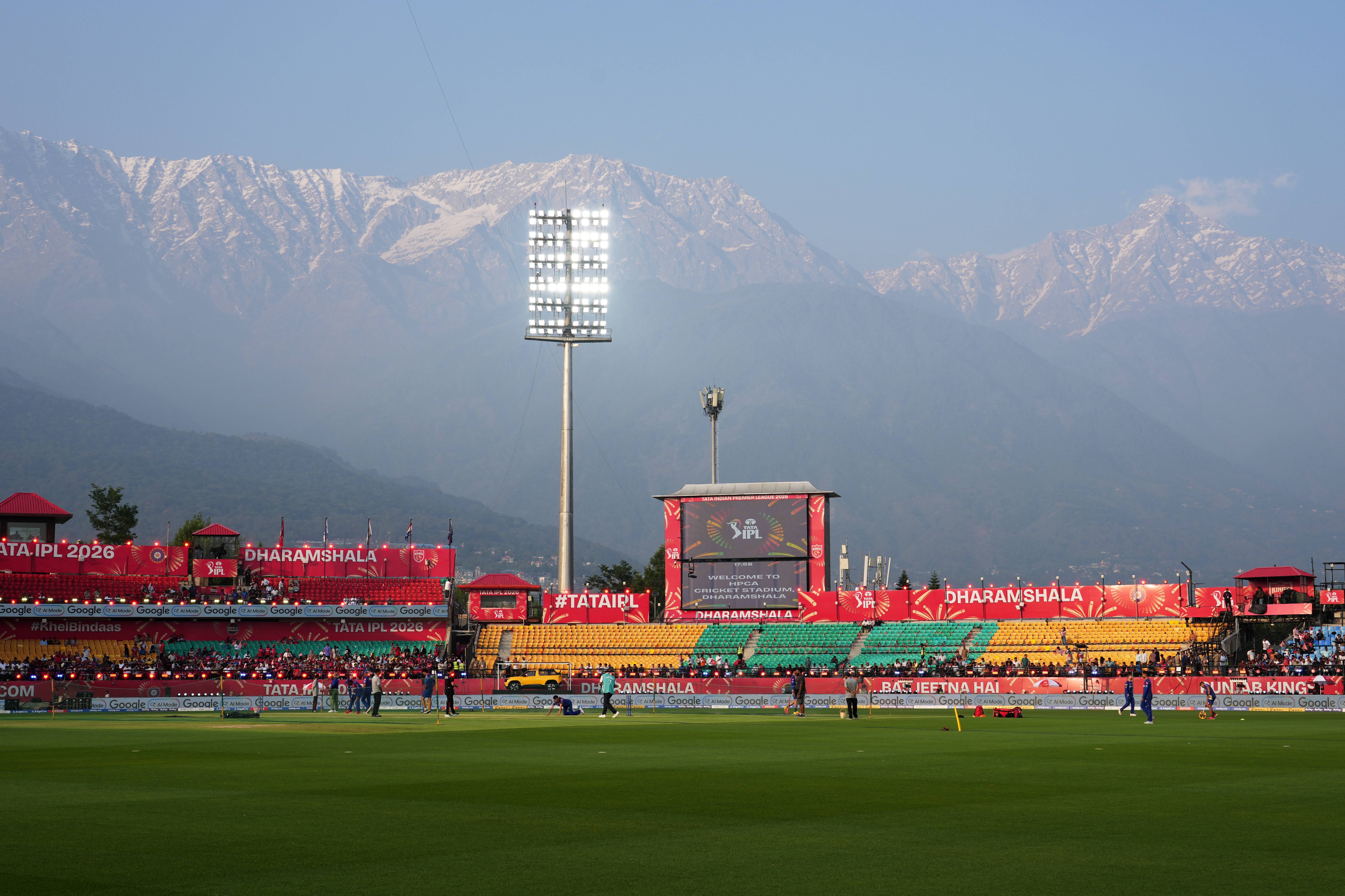 The Dhauladhar range of the Himalayas is visible in the background as players warm up before the Indian Premier League cricket match between Delhi Capitals and Punjab Kings at HPCA Stadium in Dharamshala, India, Monday, May 11, 2026. Photo: Ashwini Bhatia/AP